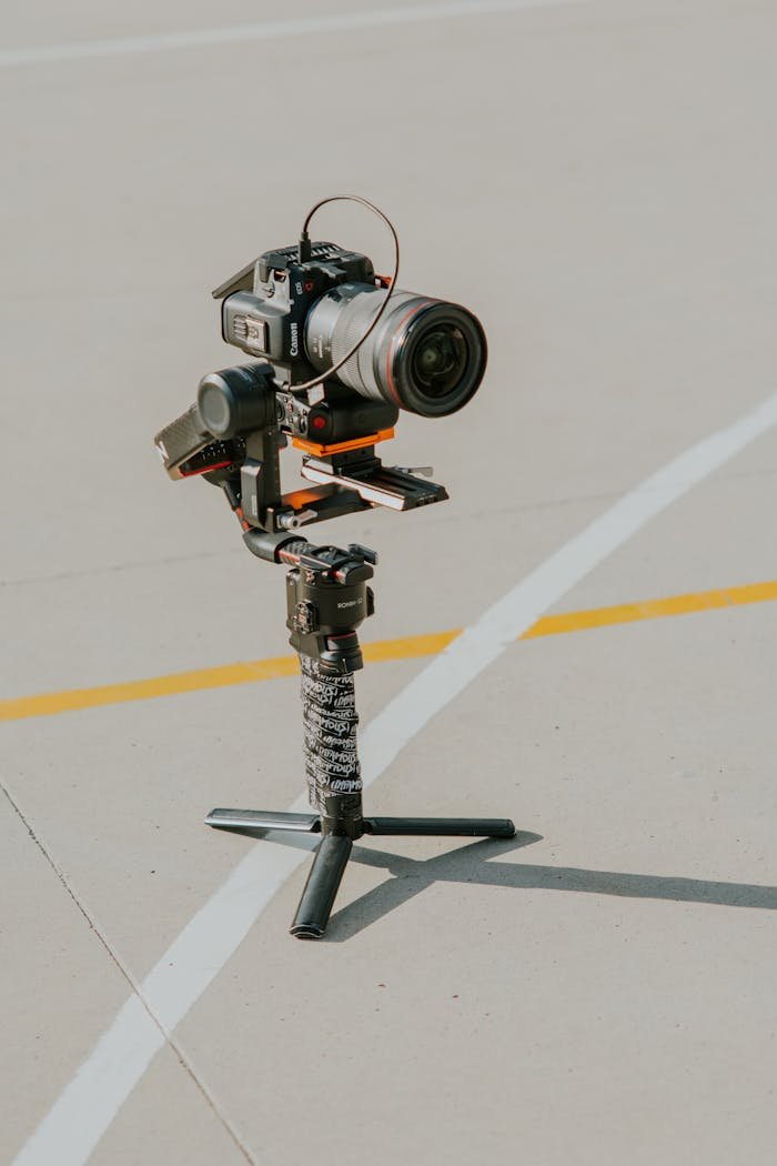Modern mirrorless camera setup on a stabilizer outdoors on a sunny day, showcasing photography technology.